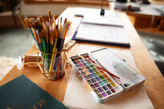 artist tools on a wooden desk