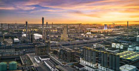 Aerial view of a large oil refinery and petrochemical industrial zone at beautiful sunset.