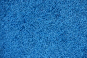 blue dishwashing sponge texture close-up macro texture of a blue dishwashing sponge. fibrous surface structure commonly used for cleaning kitchen utensils and surfaces. perfect for backgrounds, cleani