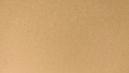 Background of brown kraft paper or cardboard texture. Abstract pattern of beige rough carton, old paper sheet, parchment or papyrus surface.