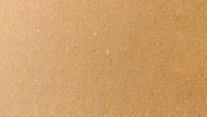 Background of brown kraft paper or cardboard texture. Abstract pattern of beige rough carton, old paper sheet, parchment or papyrus surface.