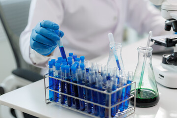 Scientist observing chemical reaction in glassware.