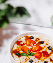Healthy breakfast bowl with berries and nuts at a sunny cafe