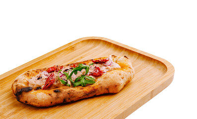 Flatbread topped with sun-dried tomatoes and herbs on a wooden tray