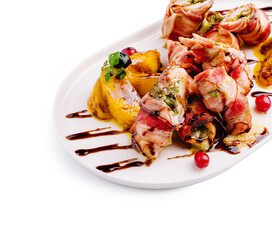 Unique culinary creation featuring rolled meat and grilled fruit