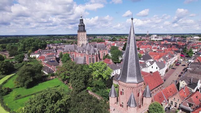 Hanseatic town Zutphen, The Netherlands, with church and city entrance tower rising above historic city against a blue sky. Aerial picturesque Dutch city