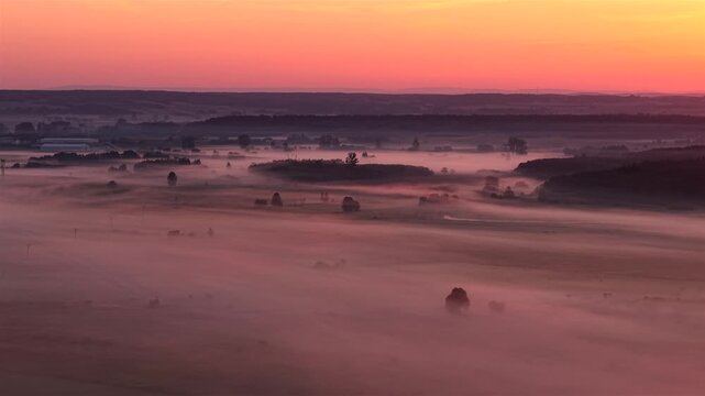 Aerial view of sunset light on foggy fields in Poland&rsquo;s Nida river valley