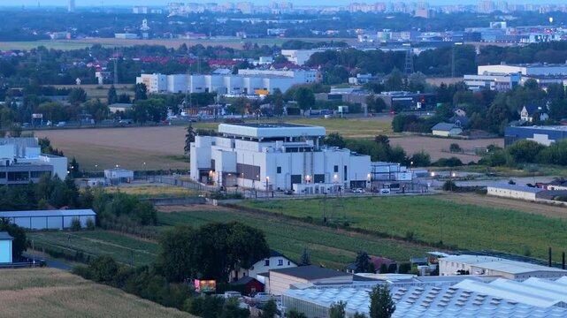 Aerial view of a modern data center in Warsaw, Poland, showing a secure server facility and communication hub within an industrial and suburban land