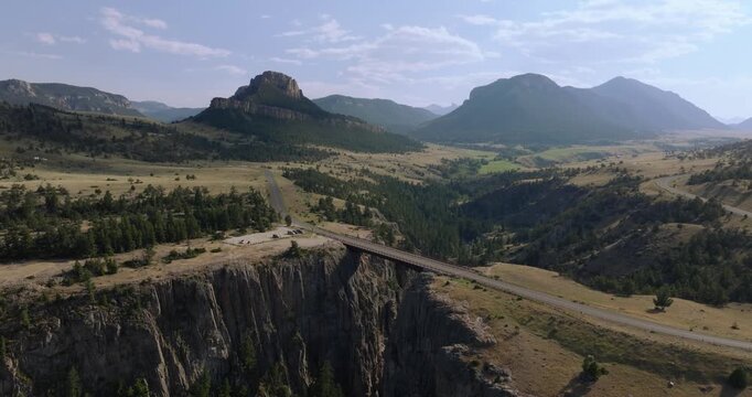 Scenic highway over bridge with mountain views, evokes adventure