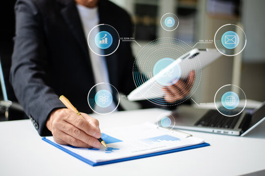 Businessman hand working digital marketing media in virtual screen with mobile phone and modern compute