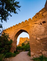Ancient stone archway leading to a fort