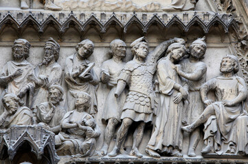 Notre Dame Cathedral. South facade. Saint-Etienne's gate tympanum sculptures depicting Saint-Etienne's life.   Paris. France.