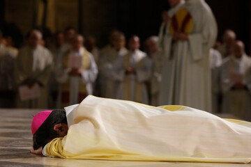 Episcopal ordination of Monseigneur Michel Aupetit in Notre-Dame de Paris cathedral. Ordinand lying prostrate before the altar..   Paris. France.