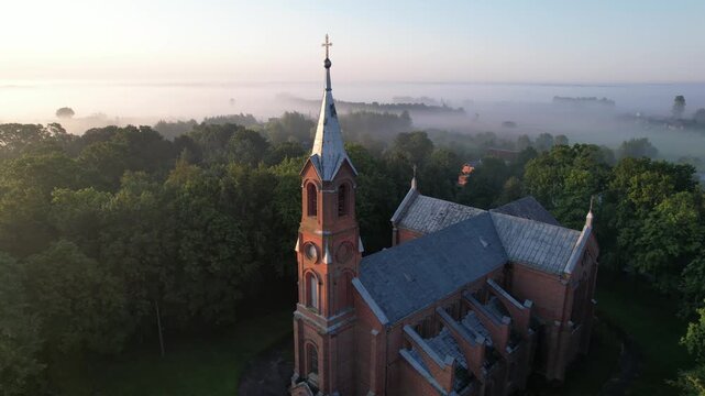 Church in the fog dawn in Krakes Lithuania