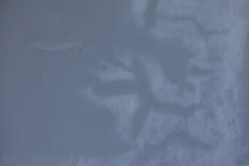 The grey painted cement floor is cracked.