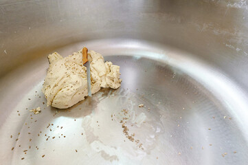Dough preparation in a bustling kitchen during early morning hours for a traditional baking session