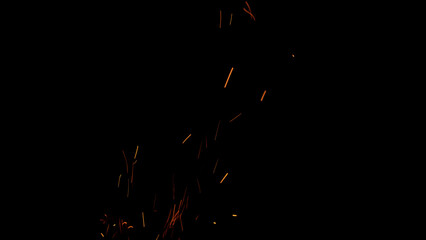 sparks and embers from campfire flying over black background