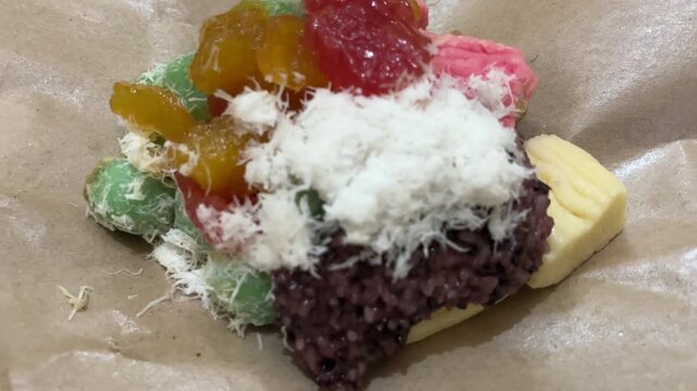 Colorful assortment of Indonesian traditional sweets including klepon, cenil, ketan, and gethuk.