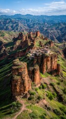 Dramatic aerial view of ancient fortress atop towering rock formations amidst green hills, under a blue sky with wispy clouds