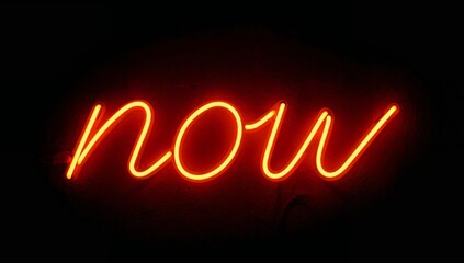 Glowing Script. The Word Now Illuminates a Dark Textured Backdrop with Warm Light.