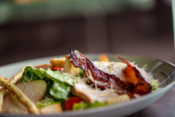 Caesar salad on a plate on a restaurant background macro photo