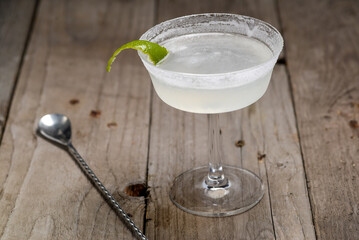 light cocktail in a glass on a wooden background