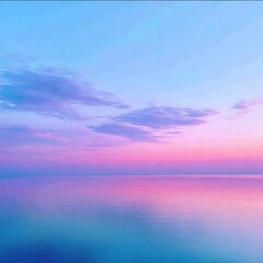 Obraz premium Serene sunset over water. Pink & blue sky with soft clouds reflects in the calm surface. Ethereal, dreamlike