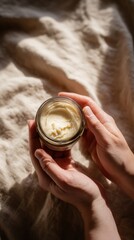 Woman holding cream jar