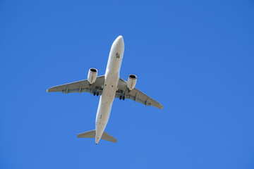 Airplane in the blue sky low angle view
