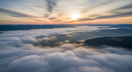 Obraz premium Aerial view of a landscape with mountains and a sea of clouds during a vibrant sunrise ai generated