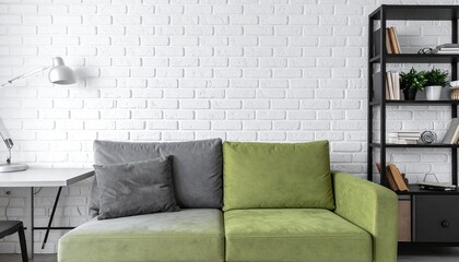 Modern white brick wall background, green and grey sofa, black furniture detail, working table with bookshelf 
