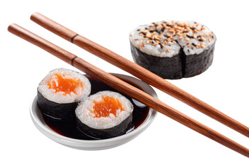 Close-up of sushi rolls with chopsticks and soy sauce. Two pieces of salmon sushi, neatly arranged in a small white bowl of soy sauce.  A third, sesame-topped sushi roll sits above.