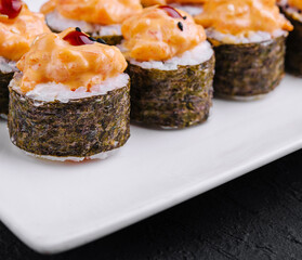 Delicious spicy tuna sushi rolls on white plate