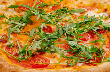 Fresh italian pizza with arugula and tomato