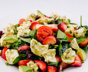 Fresh mixed salad with avocado and strawberries