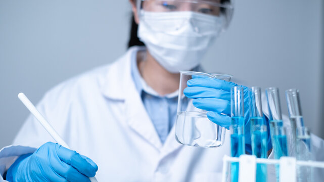 Professional Asian woman scientist chemist technician experiment research in chemistry laboratory data analysis result report scientific innovation document