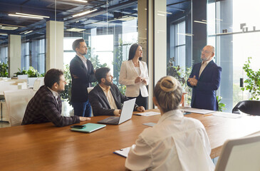 Business meeting in office with team of colleagues and leader, employees listen to speaker and senior mentor. Success presentation and briefing, corporate teamwork training in boardroom