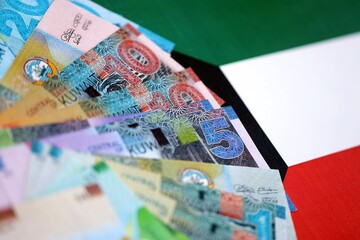 Kuwaiti dinar currency money bills lies on flag. The concept of business and investment
