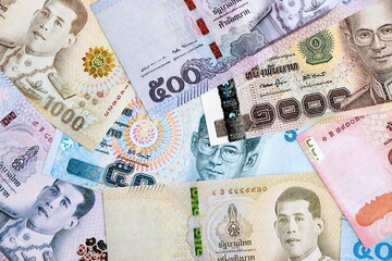 Thai baht currency money. The current banknotes lies on table in big amount