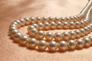 Pearl necklace on silk fabric