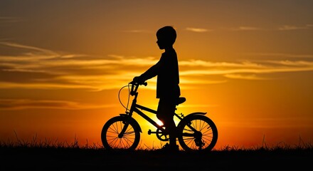 Obraz premium A childs silhouette stands with a bicycle against a sunset sky