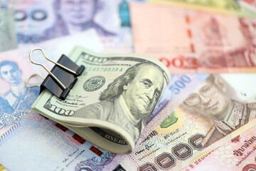 Thai baht currency money bills and bunch of us dollars. The concept of currency exchange