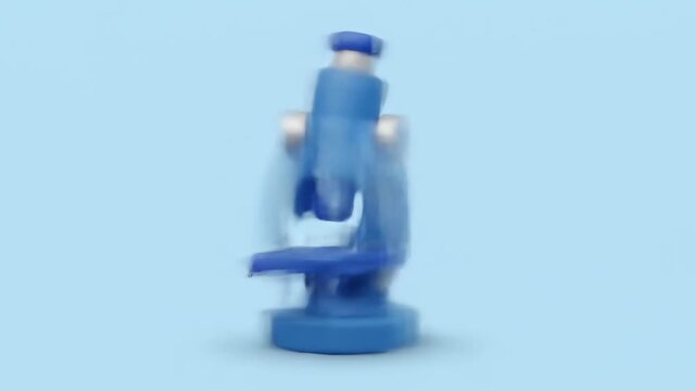 A cartoon-style, blue microscope stands against a light-blue background. It has a rounded base, a central cylindrical body, and eyepieces