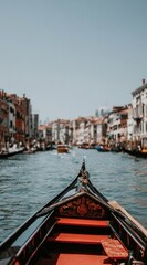 Fototapeta premium Gondola view, water canal with historical buildings line up in Venice. Perspective shot on a sunny day, warm light