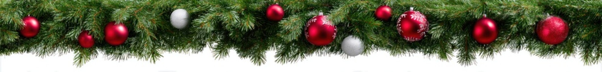 Defocused Christmas garland with red and silver ornaments, draped against a white background, creating a festive and blurry effect