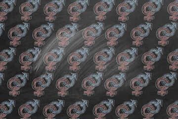 A chalkboard is decorated with repeated gender symbols in pink and blue.