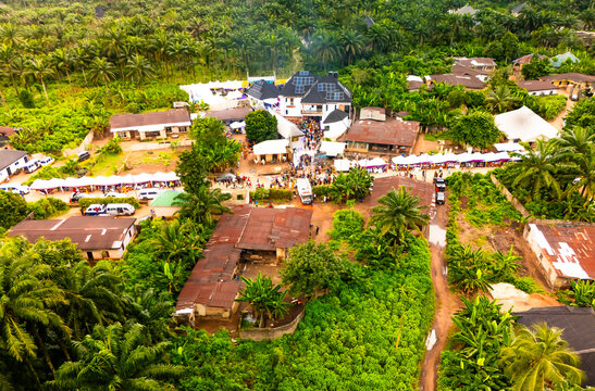 Aerial view of a vibrant community nestled amidst lush greenery, showcasing a blend of traditional and modern architecture, Amaolu Community, Orlu, Imo, Nigeria.