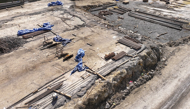 Aerial view of a construction site with exposed rebar and scattered blue tarps paints a scene of urban transformation, Istanbul, &Auml;&deg;stanbul, T&Atilde;&frac14;rkiye.