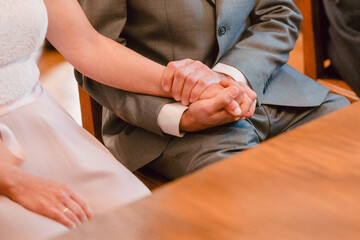 Obraz premium Couple Holding Hands During Wedding Ceremony