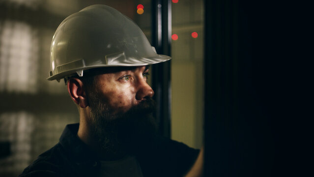 Man, technician and check machine in server room for inspection, electric maintenance and diagnostics. Male person, hardhat and database to repair cables, monitor system and troubleshooting of safety